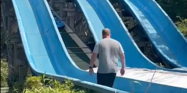 Father rescues daughter on water slide