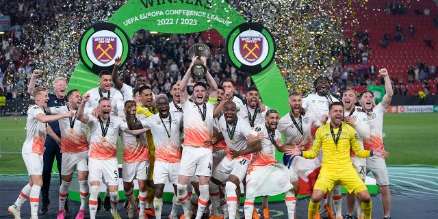 West Ham players celebrate with trophy