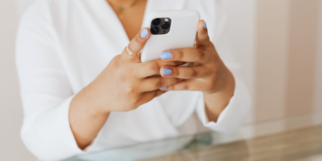 Female Apple iPhone user types on screen