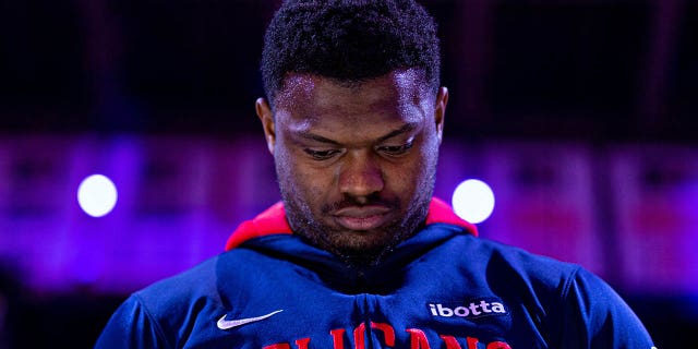 Zion Williamson listens to the anthem