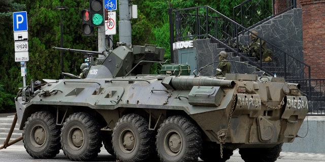 An armoured personnel carrier parked in Rostov as Wagner group mercenaries patrol the area