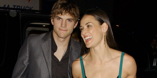 Demi Moore shows some skin wearing a sheer green dress with black lace bra for date with Ashton Kutcher