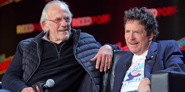 Michael J. Fox and Christopher Lloyd laugh during Back to the Future reunion panel