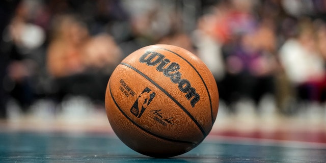 A single basketball on an empty court