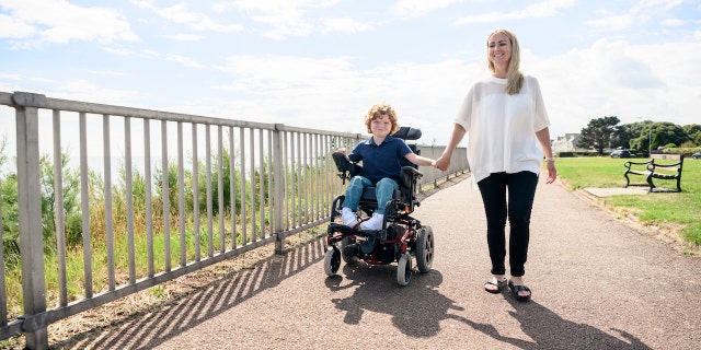 Boy in wheelchair with mom