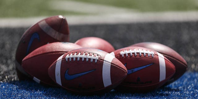 Footballs sit on the field during a Buffalo Bulls game