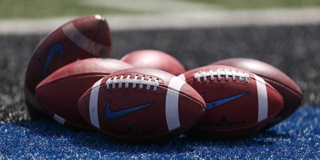 Footballs sit on the field during a Buffalo Bulls game