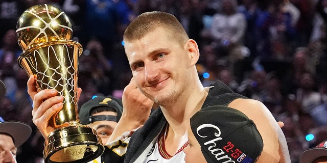 Nikola Jokic smiles with the trophy