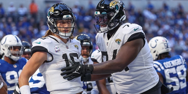 Trevor Lawrence and Cam Robinson celebrate