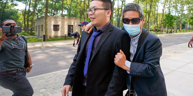 Zhu Yong outside as he walks into court