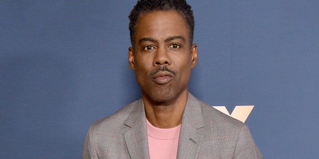 Chris Rock wears grey suit on red carpet