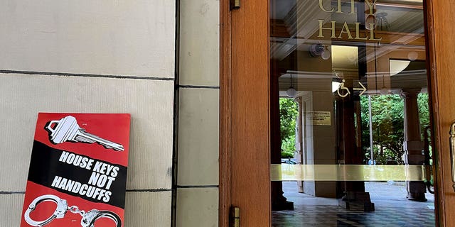 Protest sign next to Portland City Hall door
