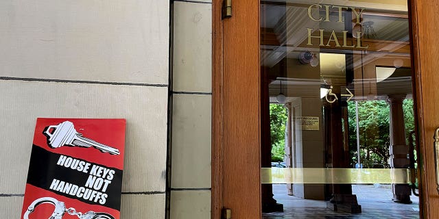 Protest sign next to Portland City Hall door