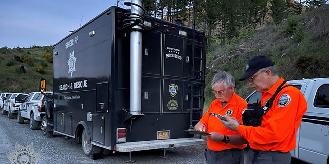 search team members along road