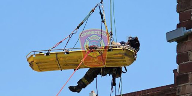 A person being airlifted on a stretcher