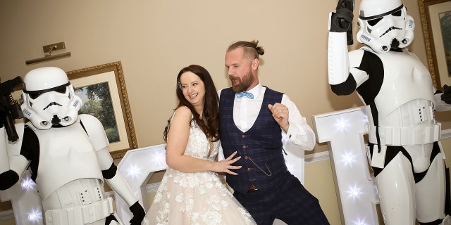 Bride and groom dance with storm troopers