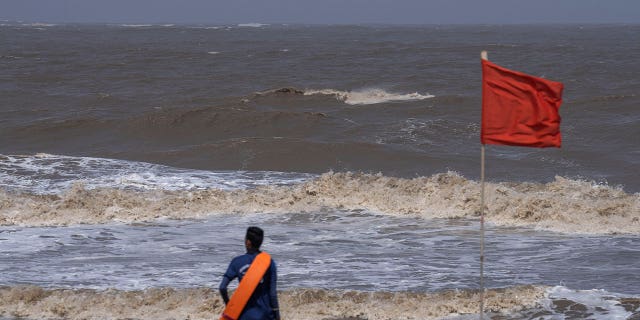 Man looks at sea in Mumbai