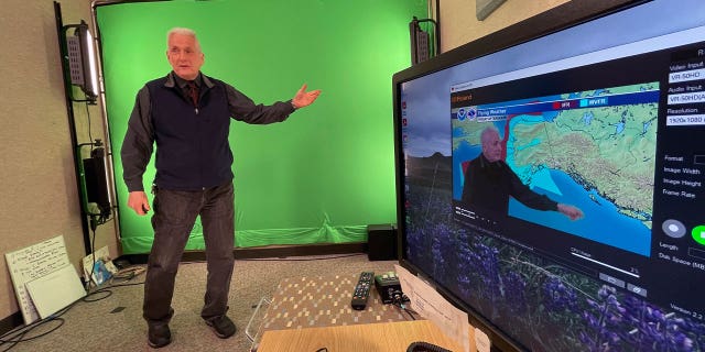 Meteorologist David Percy filming