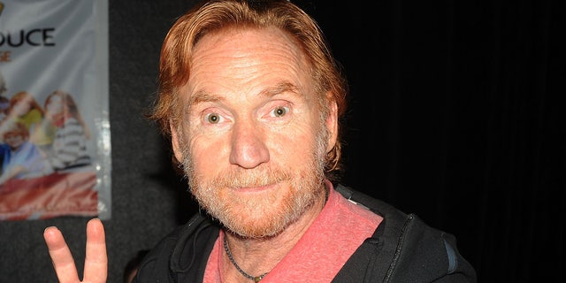 Danny Bonaduce flashes a peace sign at theater panel