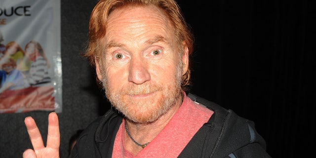 Danny Bonaduce flashes a peace sign at theater panel