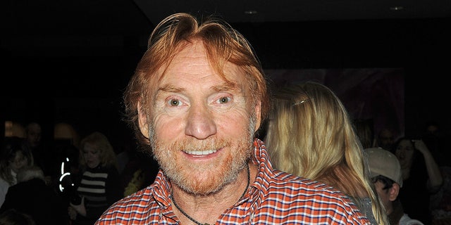 Danny Bonaduce wears plaid shirt with a necklace at event