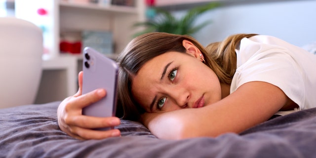 Depressed teen on phone