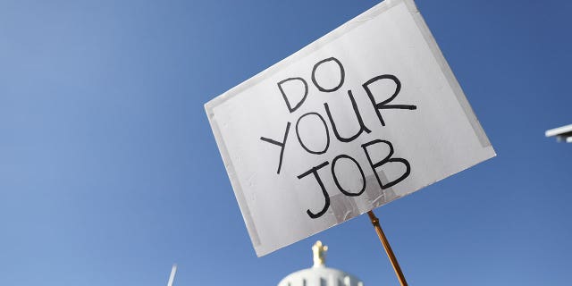"Do your job" sign