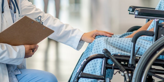 Doctor with patient in wheelchair