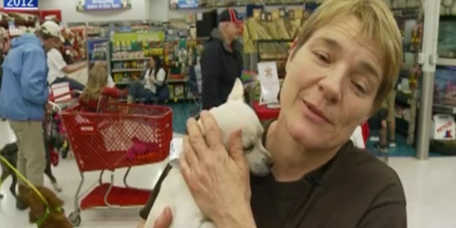 Barbara Wible holding a dog in 2012