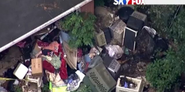 Dog crates piled outside Barbara Wible's home