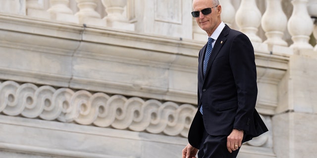 Florida Senator Rick Scott descends the steps of the U.S. Capitol