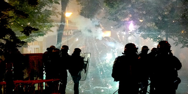 Fireworks are shot at French police during a riot in Nanterre, outside of Paris