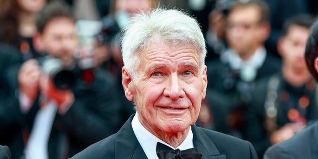 Harrison Ford wears a tux on the red carpet at Cannes Film Festival.