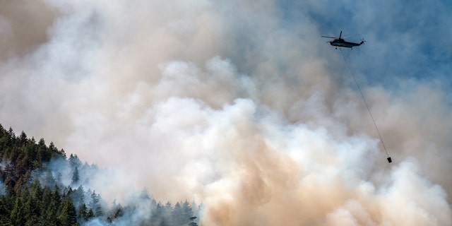 Helicopter drops water on Canadian wildfire