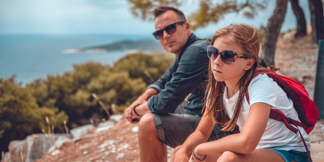 dad and daughter at odds while sitting outside