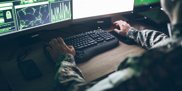 us soldier working on a computer
