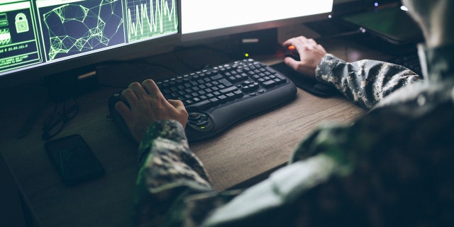 us soldier working on a computer