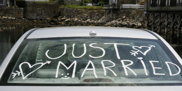 Rear car window with "Just Married" written on it.