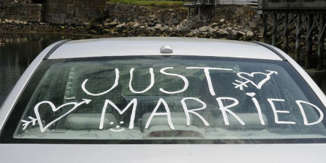 Rear car window with "Just Married" written on it.