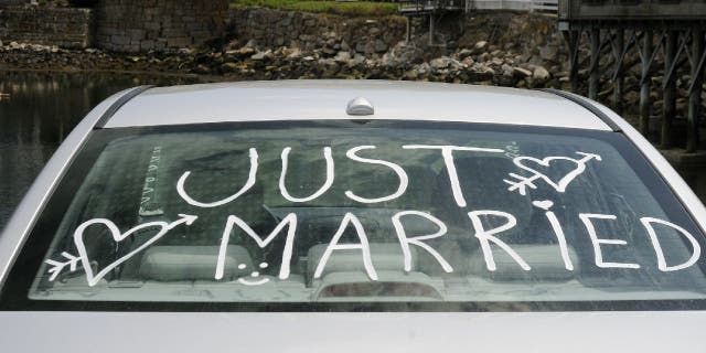 Rear car window with "Just Married" written on it.