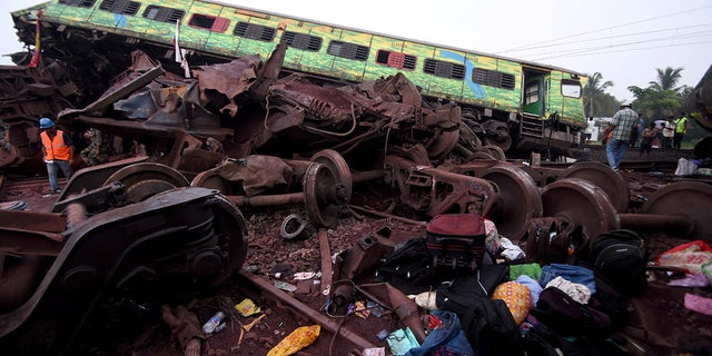 Passenger belongings are lie next to a damaged rail car