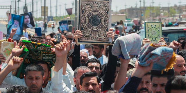 Iraqis holding the Quran