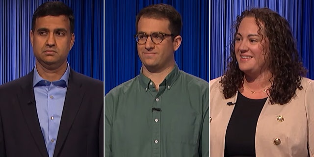 Three contestants from "Jeopardy!" all look slightly to the right on stage