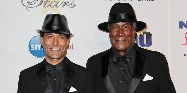 John Amos matches son KC with black leather fedora and snazzy black suits