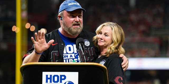 Zac Brown Band musician John Driskell Hopkins wears blue hat and t-shirt with wife