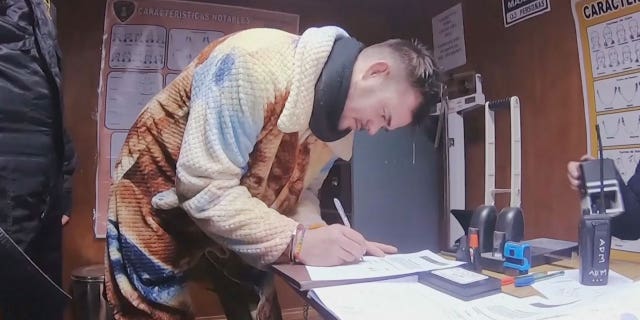 Joran van der Sloat bending down to sign a document