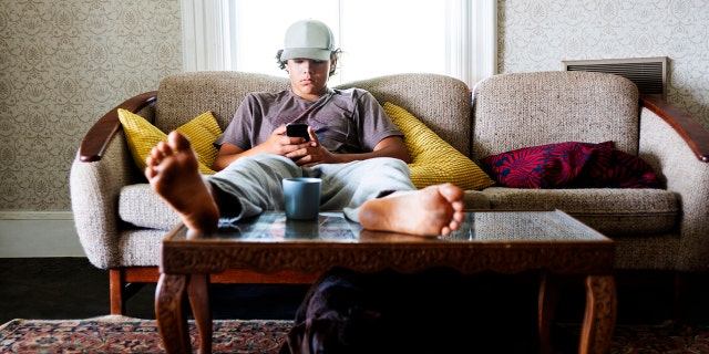 lazy teen boy on couch