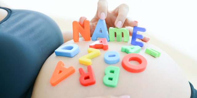 pregnant belly with letters
