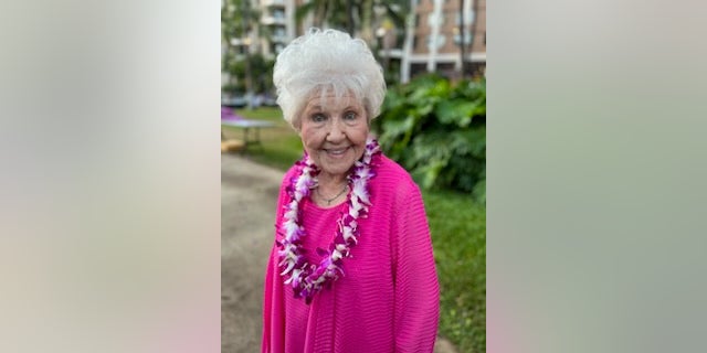 Melba standing outside wearing a lei