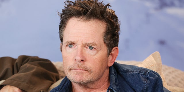 Michael J. Fox mengenakan kemeja biru selama pemutaran perdana film dokumenter di Sundance
